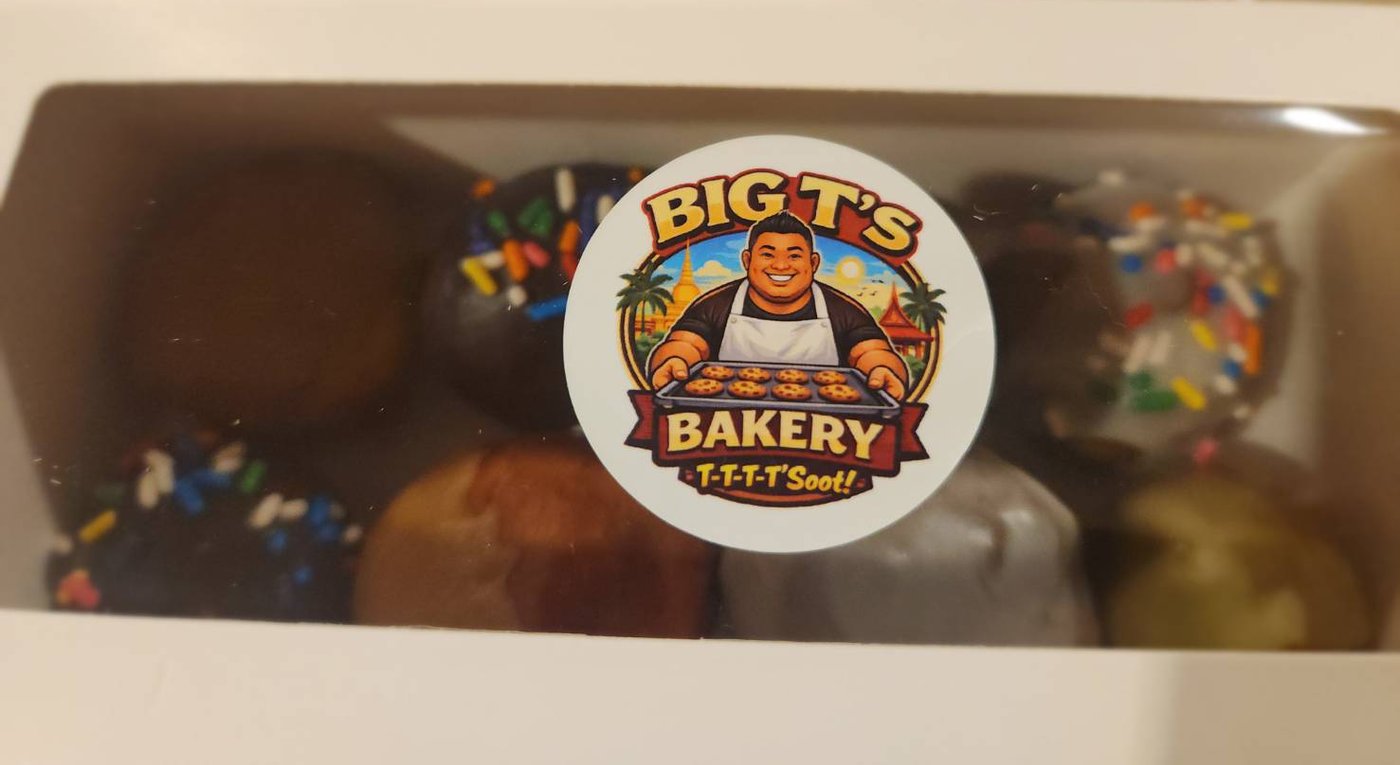 A box of Big T's Bakery treats with the bakery's sticker on the lid