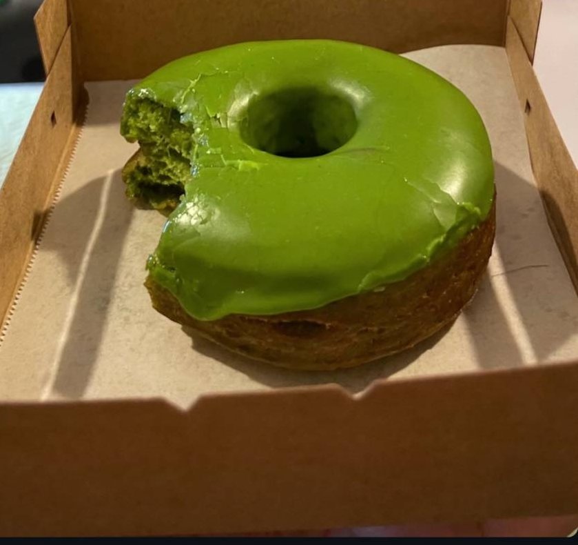 A matcha-glazed donut in a Big T’s Bakery box